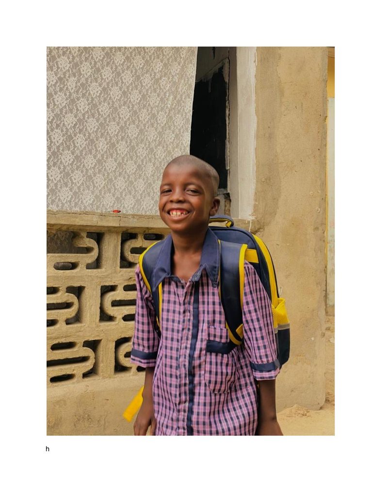 Mohammed Ali grinning with his new school bag